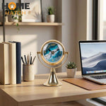 Luxury golden metal table clock with ocean-themed dial on white background