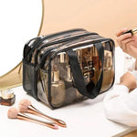Transparent multi-layer cosmetic and toiletry organizer bag with zippered compartments, carrying handles, and large capacity by Home Hatch