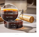 Multi-purpose glass server with wooden handle, used for coffee, milk, sauces, salad dressings, and condiments.